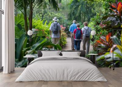 Group of people enjoys a guided walk among the lush greenery and vibrant flora of a botanical garden Wall mural