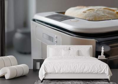 Sleek bread making machine displaying a digital timer and working on a loaf of bread Wall mural