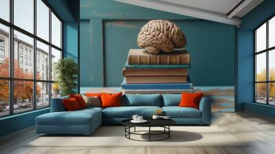 Vintage wooden table with a stack of old textbooks on neuroscience and psychology for academic study and research in cognitive science and mental health Wall mural