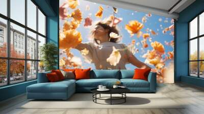 A beautiful young girl dances in nature, spring flowers  peach fuzz color swirl and fly around her. Wall mural