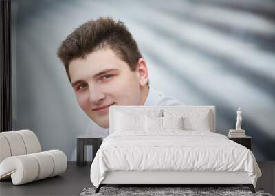 Close up portrait of a handsome young smiling man Wall mural