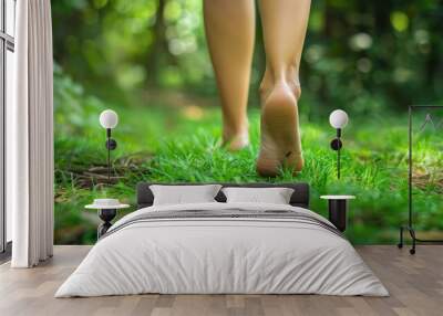 Bare feet walking on a green grass path in forest, displaying sense of freedom and connection with nature Wall mural