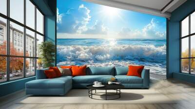 Bright sun over ocean waves crashing on sandy beach under clear blue sky with clouds Wall mural