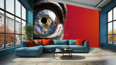 Close-up of eye with Earth as iris against red background Wall mural