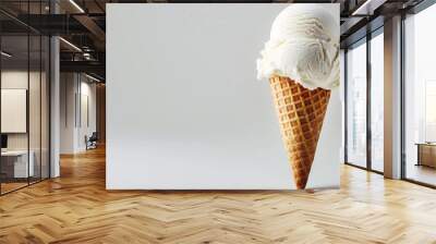 Ice cream cone with vanilla ice against plain background Wall mural