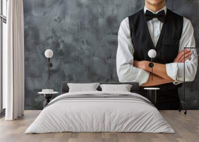 Person in formal black vest and bow tie with folded arms Wall mural