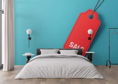 Red sale tag on blue background Wall mural