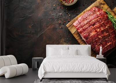 Sliced raw steak on wooden board with herbs and spices Wall mural