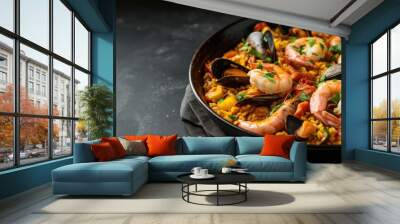 Traditional seafood paella in a pan, vibrant ingredients on dark surface Wall mural