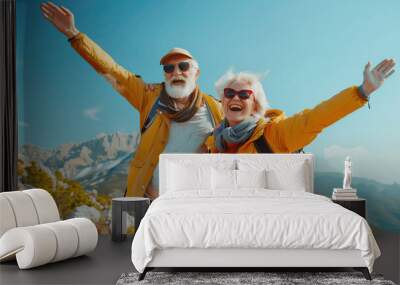 Two happy active seniors having fun at the top of the mountain. Couple of mature people enjoying and having fun in vacations. Traveling lifestyle Wall mural