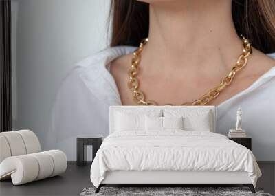 Beautiful model brunette in modern gold metal necklace chain Wall mural