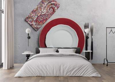 Simple minimal table setting with two dishes, silverware and napkin on gray background Wall mural