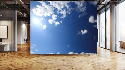 Sky background with clouds and sun Wall mural