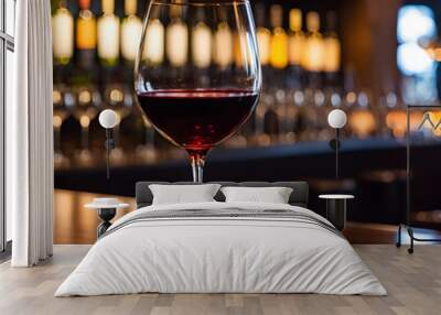 Glass of red wine on the bar counter in a pub or restaurant Wall mural