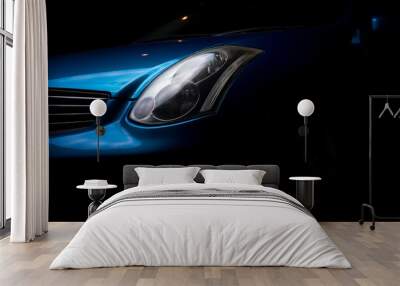  Headlight car. Headlight blue sports car. Part of the blue car on a dark background. Wall mural