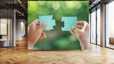 two hands hold puzzle pieces Wall mural