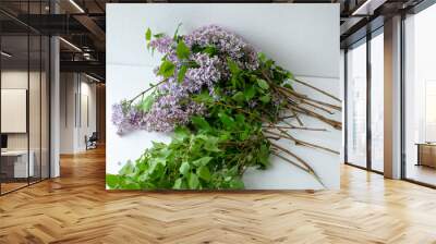 A close up of a flower. A bouquet of lilac lies on the table. Wall mural