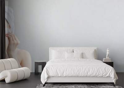 Beauty portrait of smiling woman in towel on head with soft healthy skin removing make up with cotton pad isolated over white background. Skincare cleansing spa relax concept. Banner Wall mural