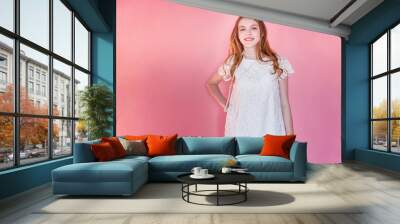 Happy teenage girl smiling. Closeup portrait young happy positive woman wearing white dress standing on pink colourful pastel trendy modern fashion pin-up background. European woman. Positive human em Wall mural