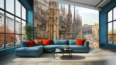 Roof of Milan Cathedral Duomo di Milano with Gothic spires and white marble statues. Top tourist attraction on piazza in Milan, Lombardia, Italy. Wide angle view of old Gothic architecture and art Wall mural