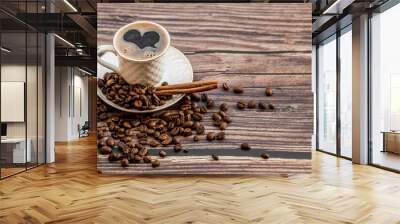 Cafes and restaurants. A mug of invigorating black coffee and coffee beans on a wooden background. Place for the label. The concept of hot drinks. Wall mural