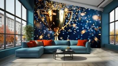 Reward.A gold cup and flying confetti on a dark blue background. Sports competitions, success, business, the concept of achievement and victory. Wall mural