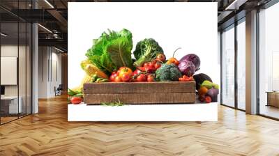 Organic vegetables and greens in a wooden box on a white isolated background. Wall mural