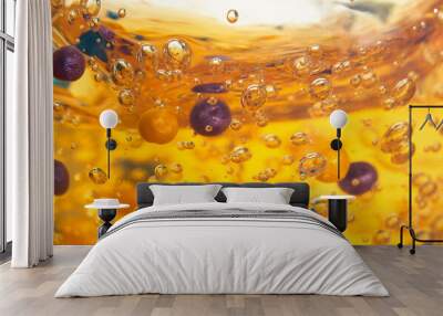 Yellow cosmetic gel with bubbles and scrub particles in a transparent container, front view. Beauty product, macro. Wall mural