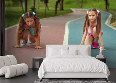 two teenage girls, one overweight girl in the starting position on the track. childhood obesity. competition Wall mural