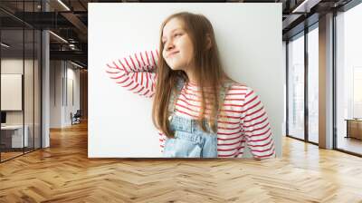 beautiful teenage girl with long hair standing against white wall Wall mural