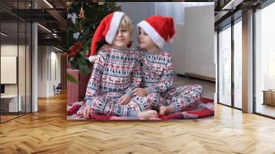 cute twins kids in santa hats celebrating christmas Wall mural