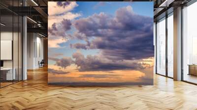 Dramatic light through the clouds against the backdrop of an exciting, bright stormy sky at sunset. panorama, natural composition Wall mural