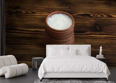 Clay glass with milk on the table Wall mural