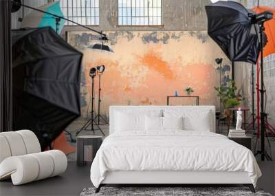 Photo studio with a variety of lighting equipment and a painted backdrop in warm colors Wall mural