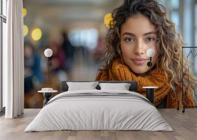 Portrait of a beautiful young woman with curly hair wearing a brown scarf Wall mural