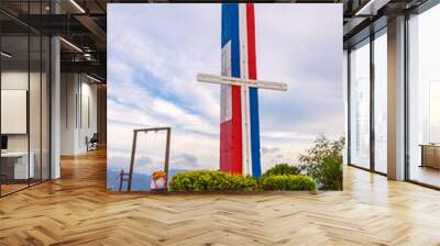 The symbol of the cross, painted in the color of the Dominican flag Wall mural