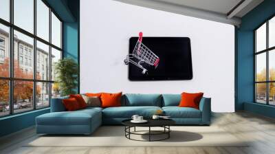 black tablet with a metal basket on a white background with space for text Wall mural