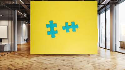 two puzzle pieces on a yellow isolated background with space for text Wall mural