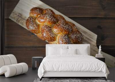 Traditional Jewish sweet Challah bread on a wood plate on wooden table / background with copy space Wall mural