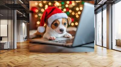 Adorable puppy wearing a Santa hat curiously looking at a laptop in front of a Christmas tree with colorful lights Wall mural