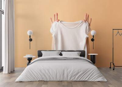 Female hands holding a white t-shirt close-up. Mock-up Wall mural