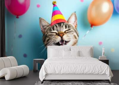 Happy cat wearing a colorful party hat surrounded by balloons and confetti at a joyful celebration indoors Wall mural