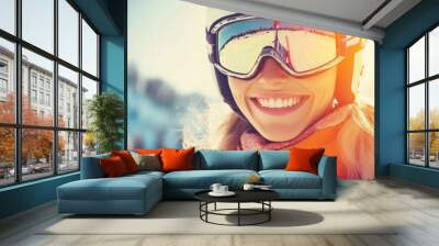 Smiling skier enjoying a sunny day on the slopes with snow-capped mountains in the background Wall mural