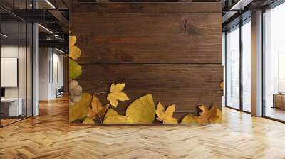 Yellow autumn leaves on wooden dark natural wood. Autumn background Wall mural