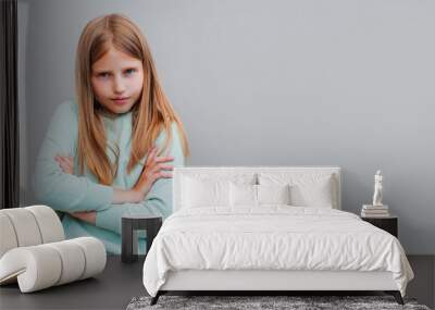 Frustrated upset lonely little girl standing in closed pose isolated on gray studio background, lonely offended blonde kid weeping feel unhappy, anxiety disorder or naughty bad behavior concept Wall mural