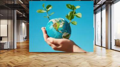 a hand gently cradling a globe with green leaves sprouting from the top, this image could serve as a powerful visual for reforestation efforts or in materials promoting sustainable living practices Wall mural