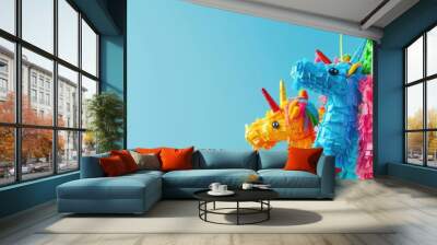 Colorful piñatas against a blue sky, representing fun and celebration, ideal for party supply ads or festive event invitations. Wall mural