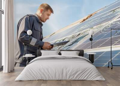 Technician examining damaged solar panels with tablet, wearing uniform, renewable energy maintenance, solar power technology, outdoor industrial setting Wall mural