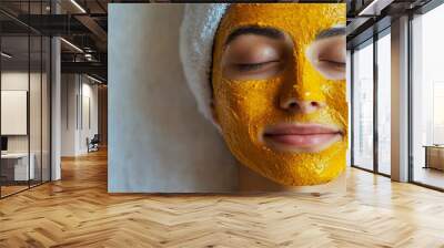 A woman relaxing with a turmeric face mask, promoting natural beauty and wellness for skin care treatments. Wall mural