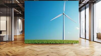 A wind turbine stands tall against a clear blue sky, surrounded by vibrant green grass, symbolizing clean energy and sustainability. Wall mural